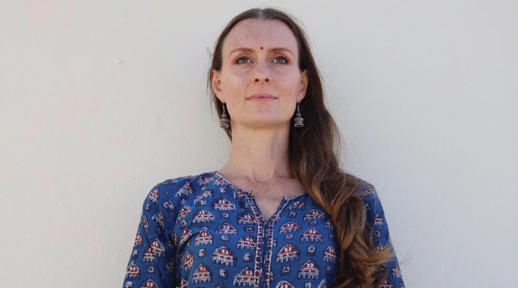 Black-and-white portrait of Amy Landry, Teacher Training behind The Ocean of Yoga