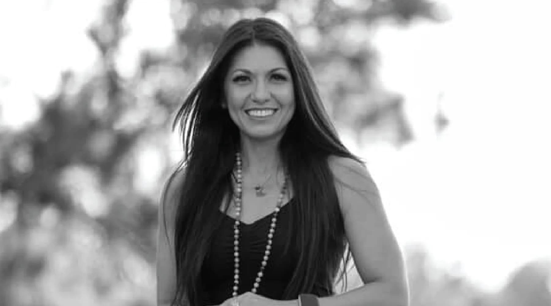 Black-and-white portrait of Kelly Sabrina Aguilar, Teacher Training behind Kelly Sabrina Aguilar